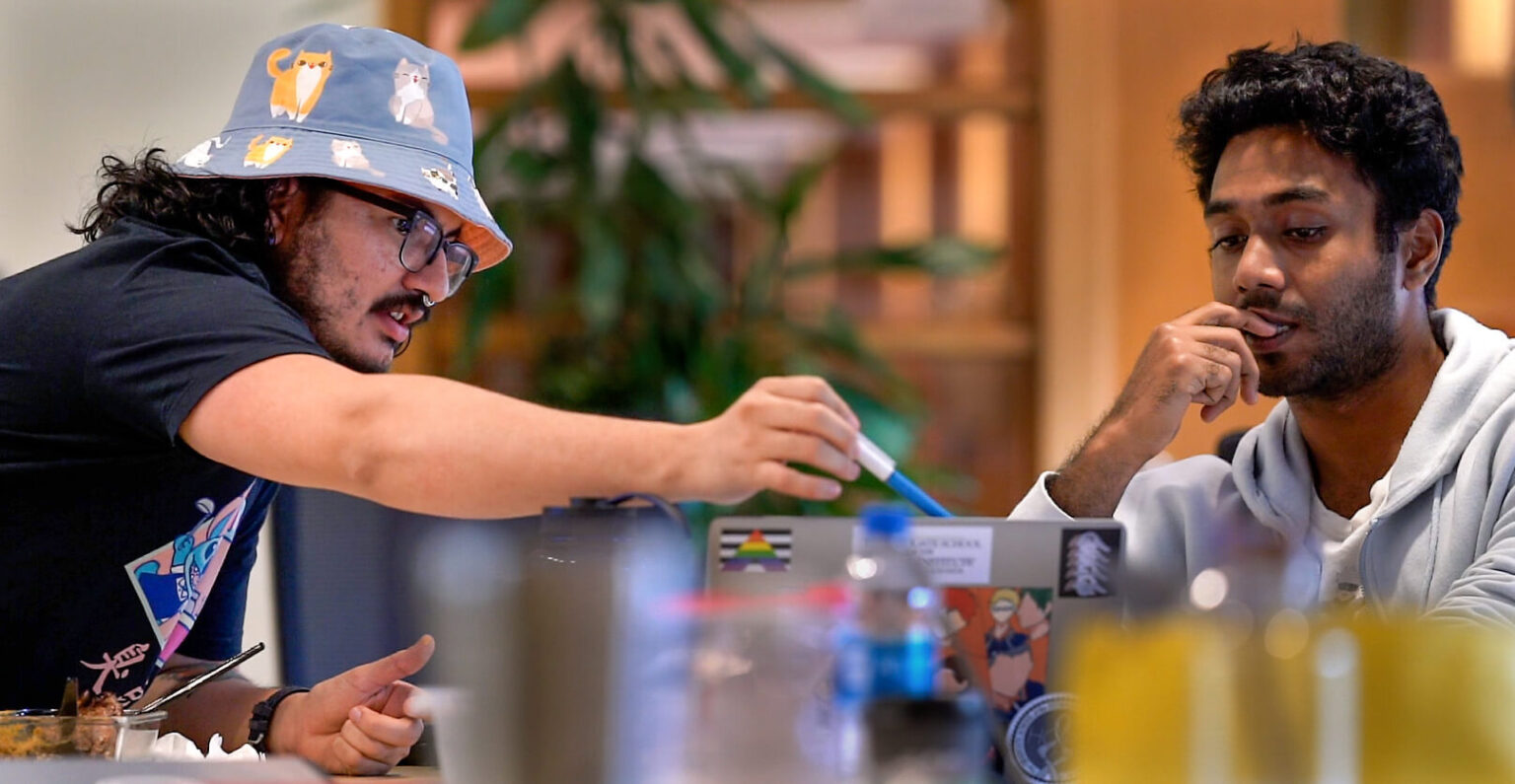 Two predocs looking at computer