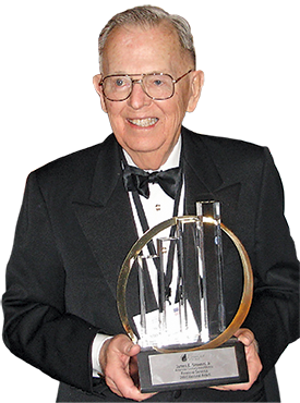 Jim Stowers holding an award