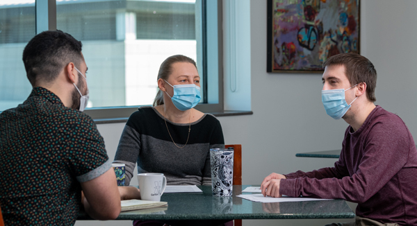 Tamara Potapova, PhD, Leonardo Gomes de Lima, PhD, and Matt Borchers sitting at a table.