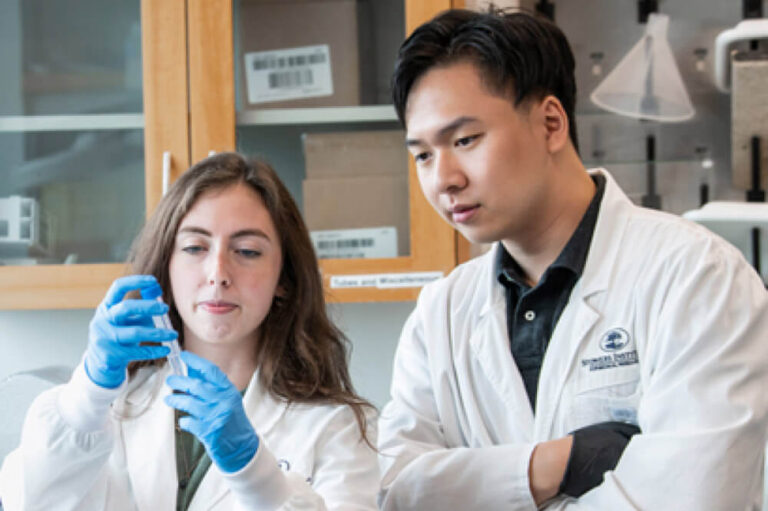 Two scientists examining a test tube