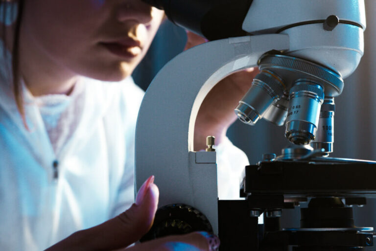 A scientist looking into a microscope